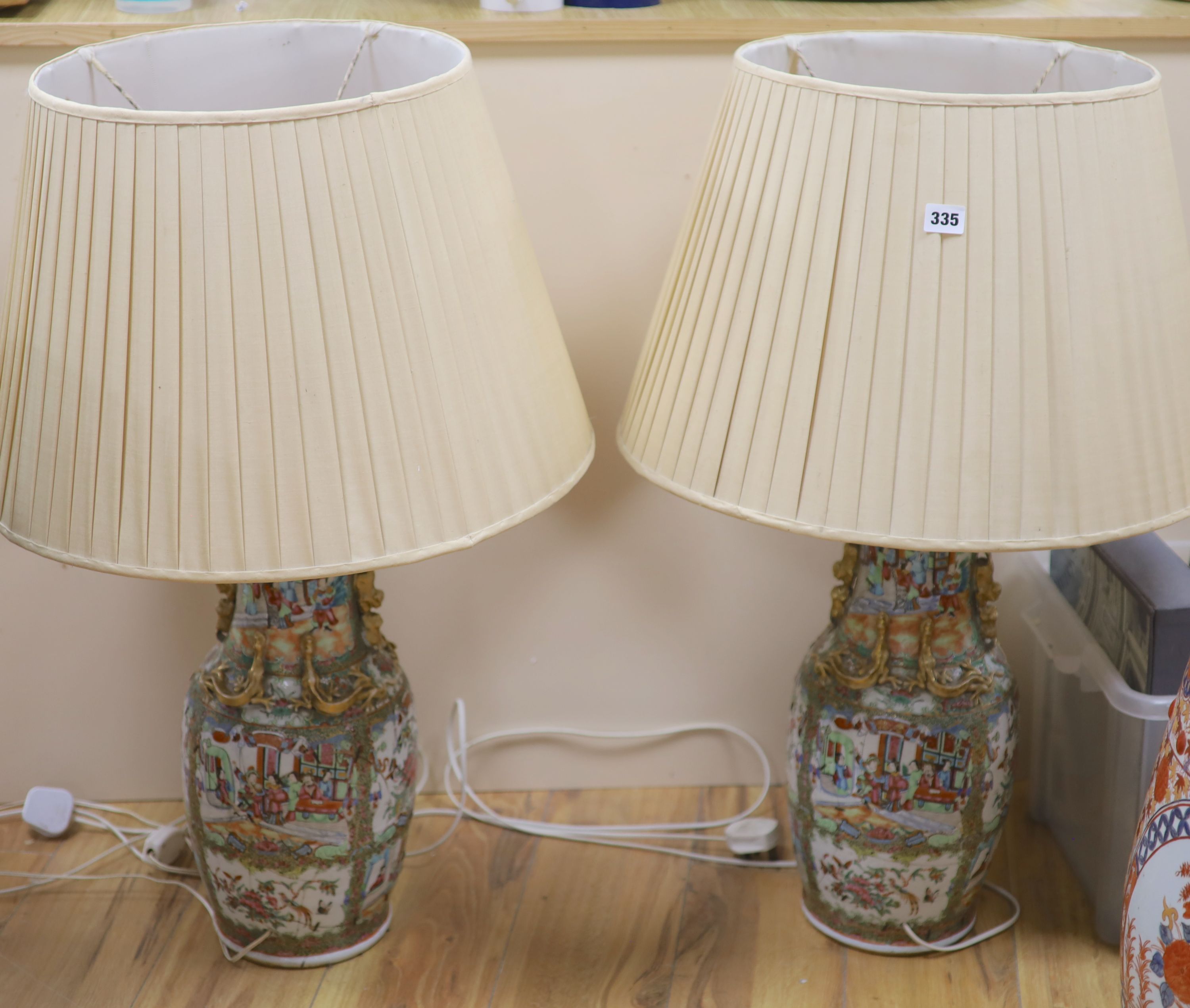 A pair of Chinese famille rose vases, mounted as lamps